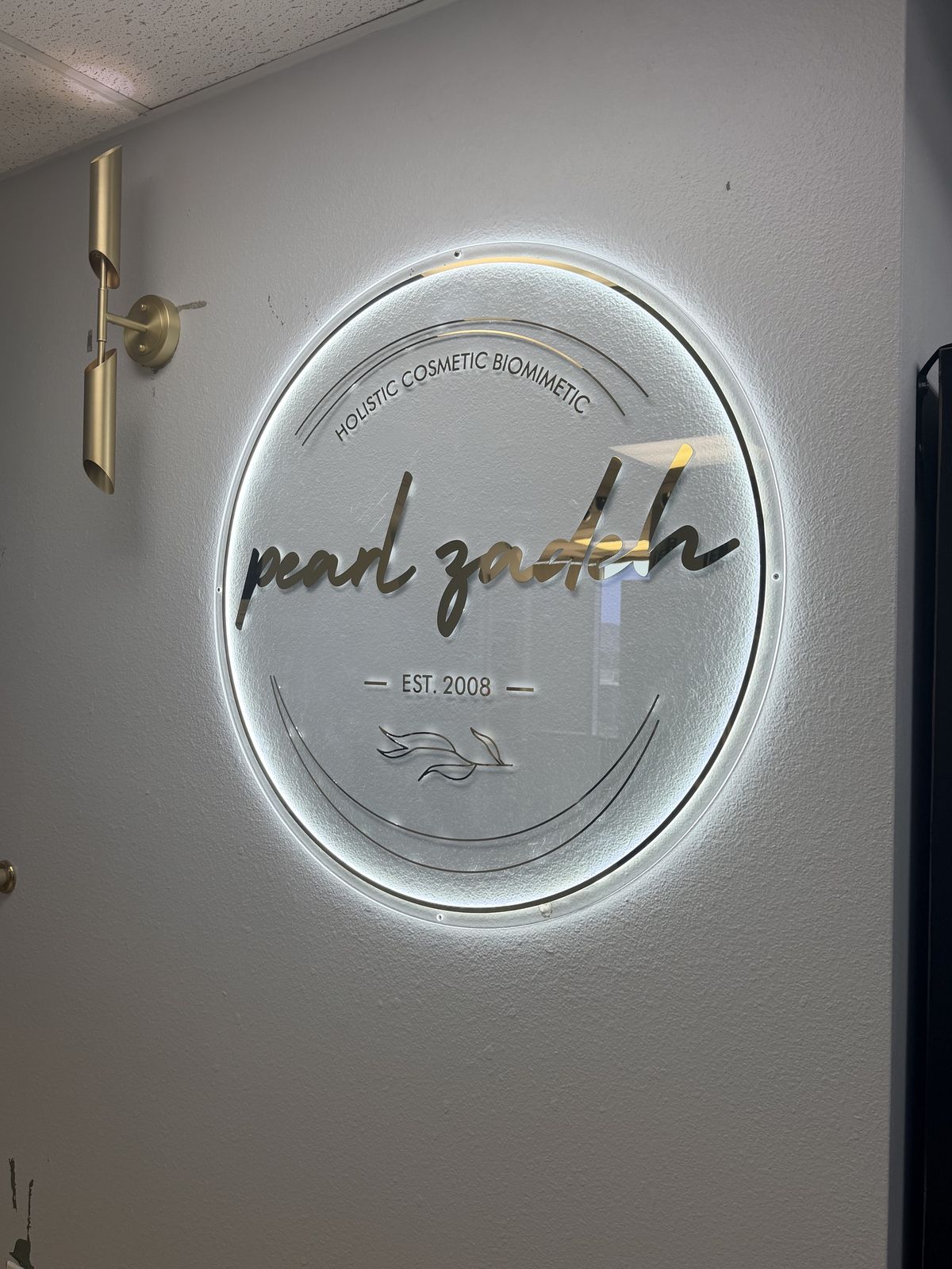 Backlit Pearl Zadeh sign, holistic cosmetic biomimetic, established 2008